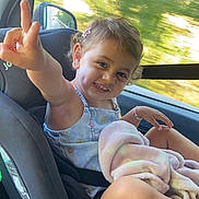Chiara a rejoint le concours — aidez-le/la à gagner de superbes lots ! toddler, child, car_seat, smile, dimples, blanket, hair_clip, window, car_interior, seatbelt, happy, gesture, summer_clothing, curly_hair, playful, portrait, sitting, outdoor_light, travel, young_child