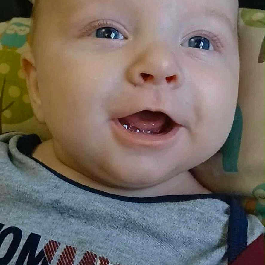 Easton joined the competition — help win amazing prizes! baby, blue_eyes, child, close_up, clothing, cushion, cute, face, happy, head, indoor, infant, pattern, person, portrait, shirt, skin, smiling, teeth, young