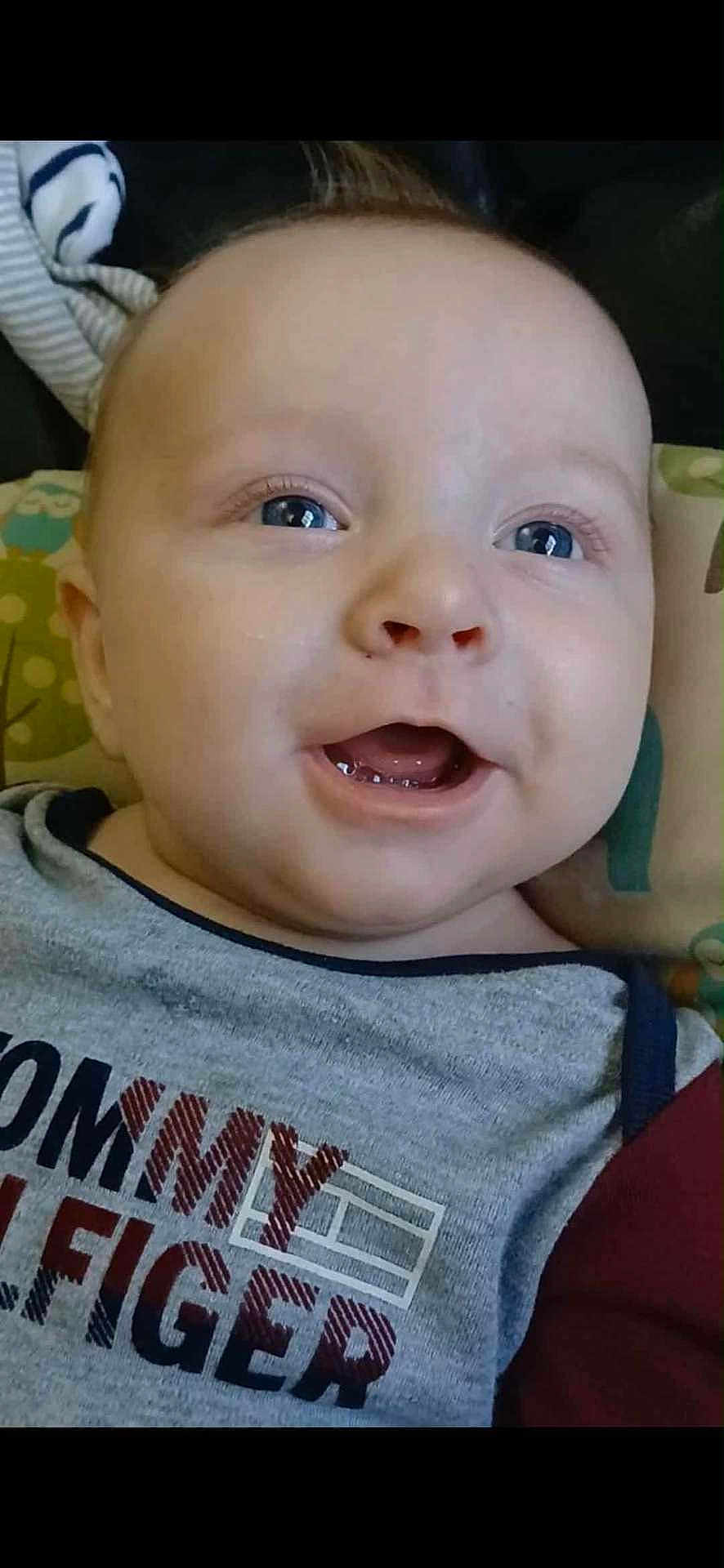 Easton joined the competition — help win amazing prizes! baby, blue_eyes, child, close_up, clothing, cushion, cute, face, happy, head, indoor, infant, pattern, person, portrait, shirt, skin, smiling, teeth, young