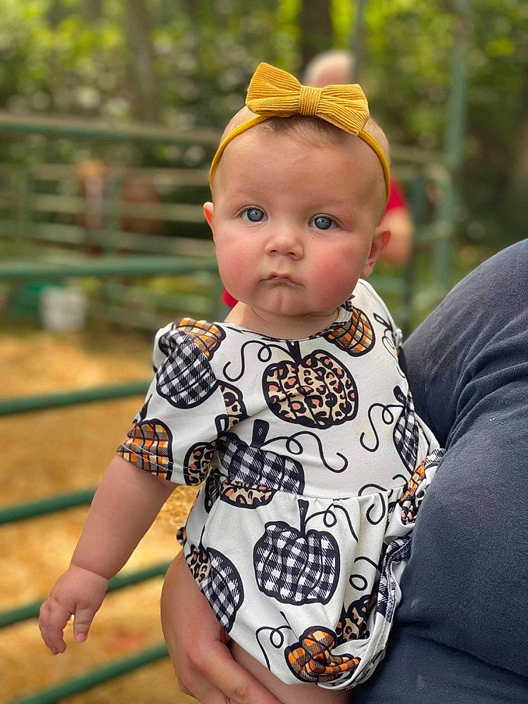 Emberleigh joined the competition — help win amazing prizes! baby, baby_toddler_clothing, cheek, child, fence, fun, grass, happy, pattern, people_in_nature, person, play, portrait_photography, sitting, skin, sleeve, toddler, tree, yellow