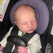 Lucas joined the competition — help win amazing prizes! baby, newborn, car_seat, sleeping, infant, child, harness, safety, smile, face, hand, clothing, purple, white, peaceful, cute, indoors, closeup, soft_light, resting