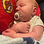 Lucas is registered to the contest to win money with this photo: baby, sleeping, pacifier, blanket, pillow, cartoon, infant, cute, peaceful, cozy, child, person, closeup, soft, rest, nap, indoors, comfort, skin, clothing