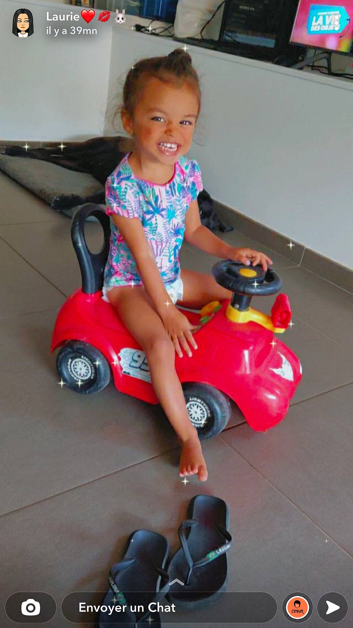 Kaïla participe au concours pour gagner de l'argent avec cette photo : automotive_design, automotive_wheel_system, baby_toddler_clothing, child, dress, flooring, fun, happy, human_leg, joy, motor_vehicle, person, riding_toy, rolling, smile, snapshot, tire, toddler, toy, toy_vehicle