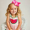 Brynlee joined the competition — help win amazing prizes! child, girl, smile, curly_hair, pink_bow, watermelon_dress, white_chair, wicker_chair, portrait, happy, cute, sitting, fashion, summer, innocence, blonde, studio, casual, colorful, fun