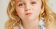 Brynlee joined the competition — help win amazing prizes! child, girl, blonde_hair, blue_bow, curly_hair, smile, playful, portrait, close_up, face, cute, pucker_lips, dress, patterned_clothing, light_background, happy, young_child, skin, person, eyelashes