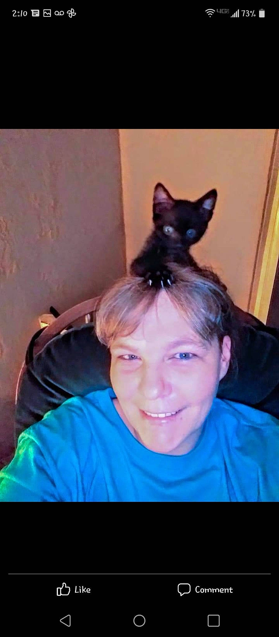 Jack is registered to the contest to win money with this photo: black_hair, cat, ear, electric_blue, eye, eyelash, face, fawn, felidae, happy, head, human_body, iris, jaw, long_hair, neck, purple, smile, t_shirt, whiskers