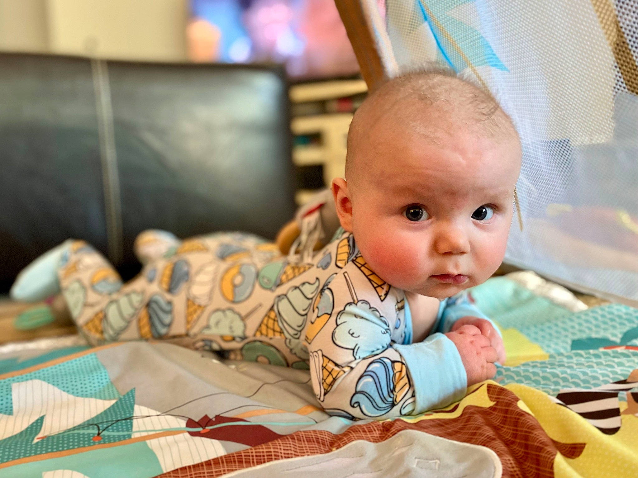 Derek is registered to the contest to win money with this photo: baby, baby_products, baby_toddler_clothing, bedding, child, comfort, computer, eye, flooring, fun, happy, leisure, linens, person, room, sitting, textile, toddler, tummy_time, vacation