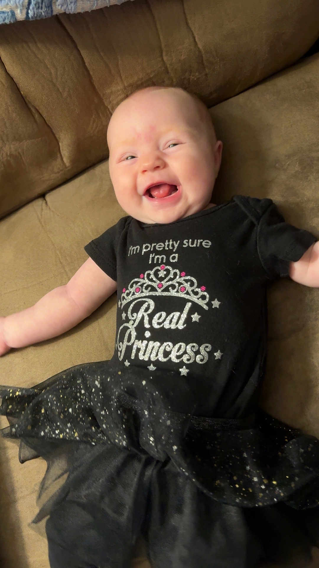 Brooklin joined the competition — help win amazing prizes! baby, infant, smiling, tutu, black_clothing, couch, happy, cute, face, person, child, sitting, sparkles, toddler, indoor, apparel, joyful, portrait, head, cheerful