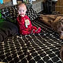 Brooklin joined the competition — help win amazing prizes! baby, child, bed, pajamas, red_clothing, polka_dots, bear_design, hand_in_mouth, patterned_sheets, black_and_white, pillow, blanket, wooden_wall, room, indoor, person, sitting, face, head, cozy