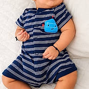 Devin is registered to the contest to win money with this photo: baby, sleeping, romper, striped_clothing, infant, peaceful, white_background, cute, child, newborn, soft, resting, portrait, small, human, skin, footwear_absent, indoors, casual, adorable