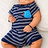 baby, sleeping, romper, striped_clothing, infant, peaceful, white_background, cute, child, newborn, soft, resting, portrait, small, human, skin, footwear_absent, indoors, casual, adorable