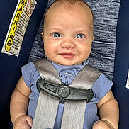 Levi joined the competition — help win amazing prizes! baby, child, car_seat, blue_shirt, smile, face, infant, seatbelt, safety, happy, closeup, human, skin, cute, young, portrait, clothing, seat, hands, indoor