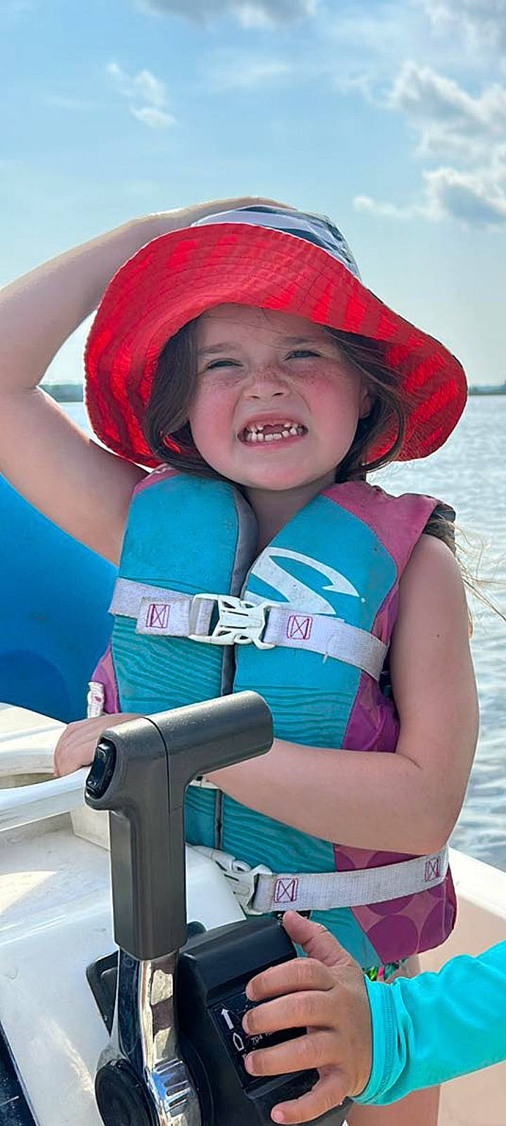Lily Mae is registered to the contest to win money with this photo: azure, cap, electric_blue, face, fun, happy, headwear, joy, lake, leisure, magenta, organ, person, personal_protective_equipment, photograph, pink, recreation, red, sky, smile