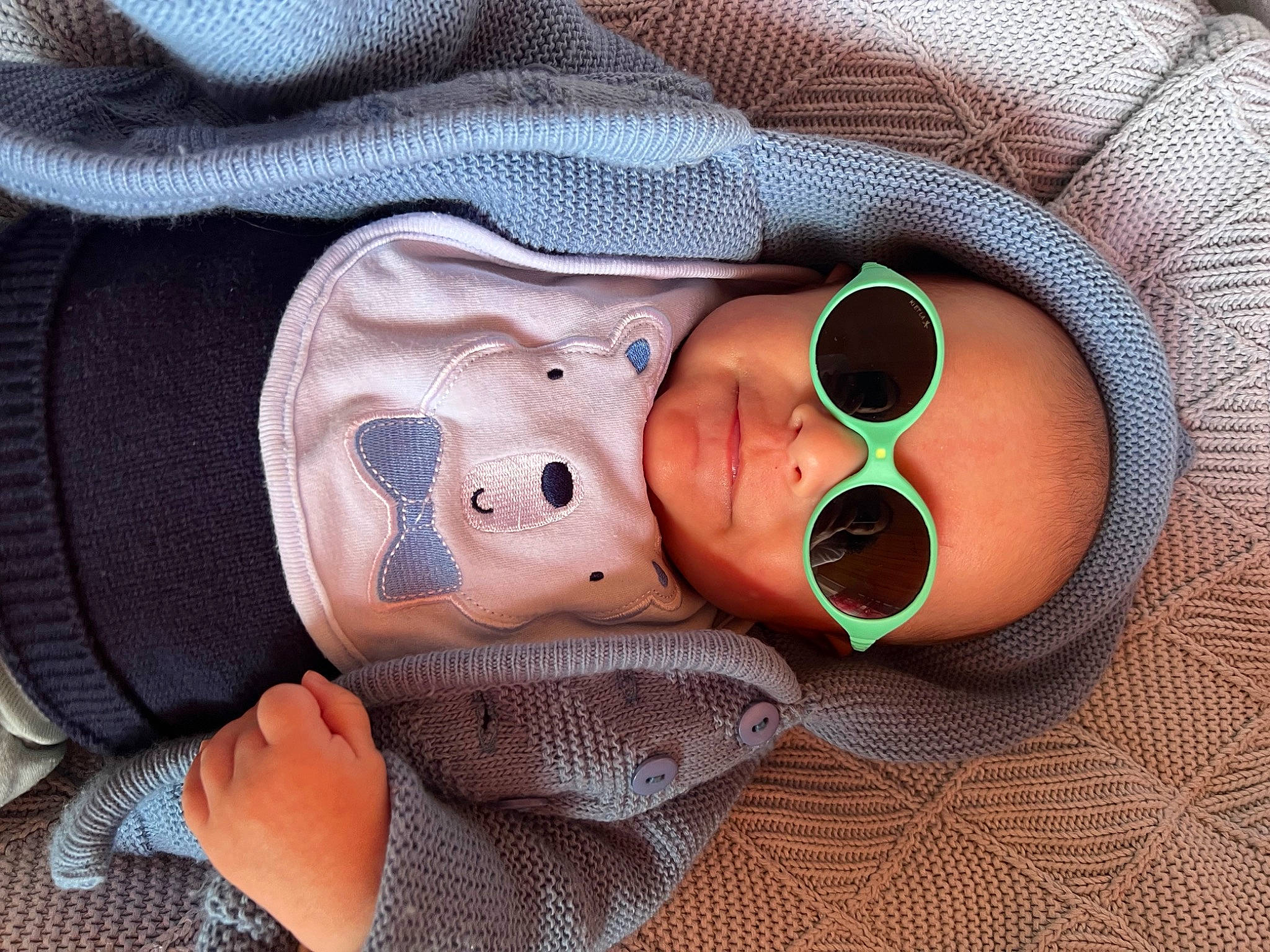 Luca is registered to the contest to win money with this photo: baby, baby_products, baby_toddler_clothing, cheek, comfort, eyewear, face, finger, glasses, goggles, headgear, linens, mouth, nail, nose, person, skin, sleeve, sunglasses, toddler