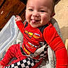 Ezekiel joined the competition — help win amazing prizes! baby, child, smiling, tongue_out, red_clothing, checkered_pattern, sitting, chair, indoors, happy, cute, person, infant, plush, race_theme, car_character, bright_colors, face, head, playful