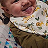 baby, smiling, tongue_out, bib, jungle_animals, patterned_blanket, colorful, infant, cute, happy, face, clothing, child, portrait, indoor, playful, young_child, baby_bib, fabric, closeup