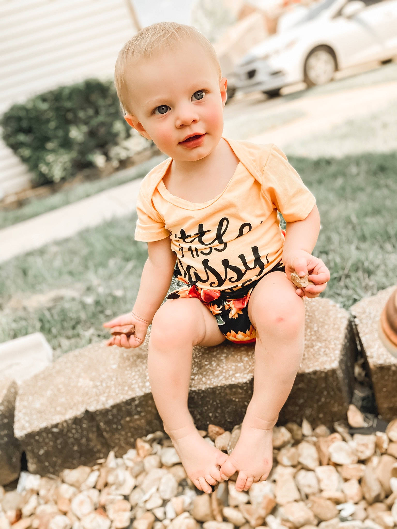 Lyrique is registered to the contest to win money with this photo: baby_toddler_clothing, child, face, finger, flash_photography, floor, flooring, grass, hair, hairstyle, happy, leg, leisure, people_in_nature, person, skin, smile, summer, t_shirt, thigh