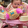 baby, child, pink, toy, plush, activity_center, indoor, carpet, feet, serious_expression, face, person, playtime, furniture, home, floor, cute, infant, legs, colorful