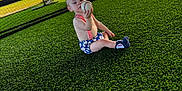 Weston joined the competition — help win amazing prizes! toddler, child, baseball, sports, grass, outdoor, field, net, sunlight, baby, sitting, shorts, socks, play, daytime, young_child, summer, fun, curious, athlete