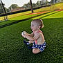 Weston joined the competition — help win amazing prizes! toddler, child, baseball, sports, grass, outdoor, playing, smiling, sitting, sunlight, batting_cage, field, fun, young_child, happy, nature, daytime, green, clothing, ball