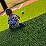 toddler, baby, child, grass, artificial_turf, baseball, ball, outdoor, sunlight, shadow, sport, crawling, playing, shorts, footwear, field, recreation, summer, activity, young_child