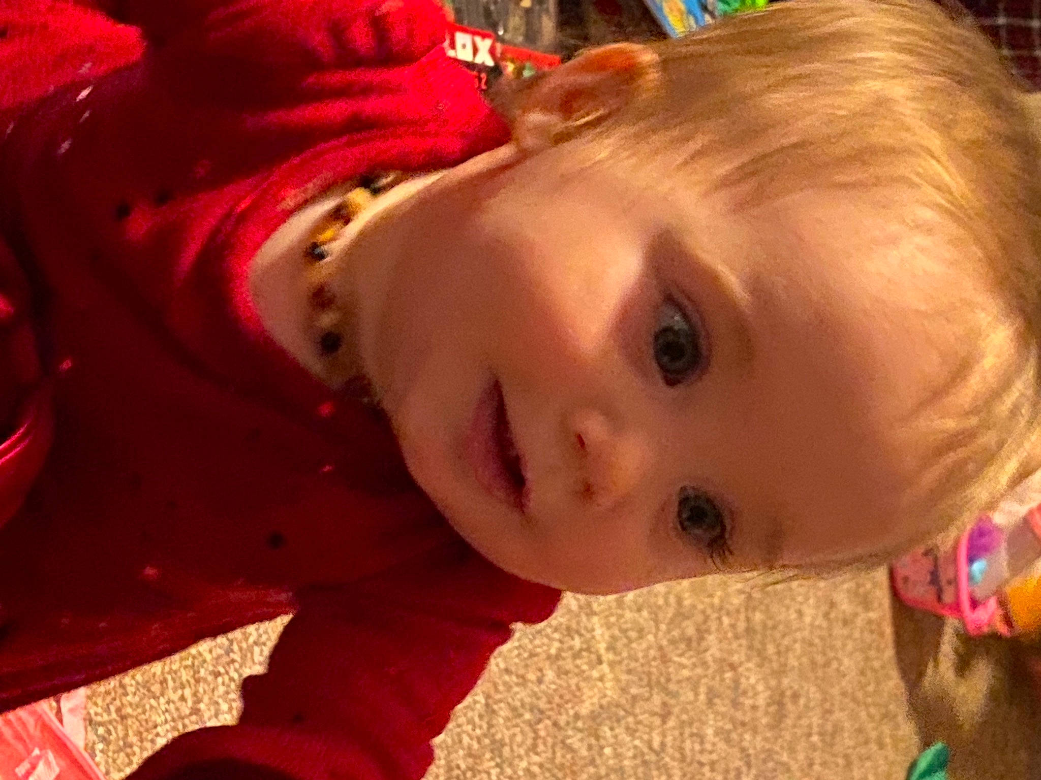 Ivy is registered to the contest to win money with this photo: baby, cheek, chin, christmas, eyelash, facial_expression, fun, happy, head, human_body, iris, lip, mouth, nose, person, plant, red, skin, smile, toddler