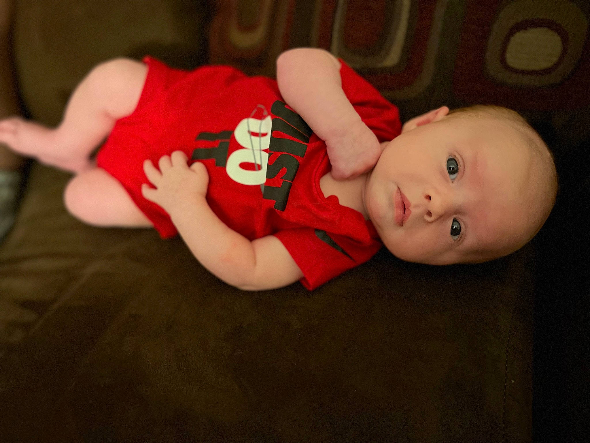 Chase is registered to the contest to win money with this photo: baby, baby_toddler_clothing, carmine, cheek, child, comfort, elbow, event, finger, flash_photography, flooring, fun, hat, human_body, human_leg, mouth, person, sitting, sleeve, toddler