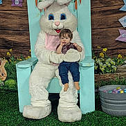 Ezryn joined the competition — help win amazing prizes! child, toddler, person, mascot, easter_bunny, costume, chair, grass, flowers, decorations, easter_eggs, bucket, wood_background, indoor, holiday, spring, cute, festival, celebration, portrait
