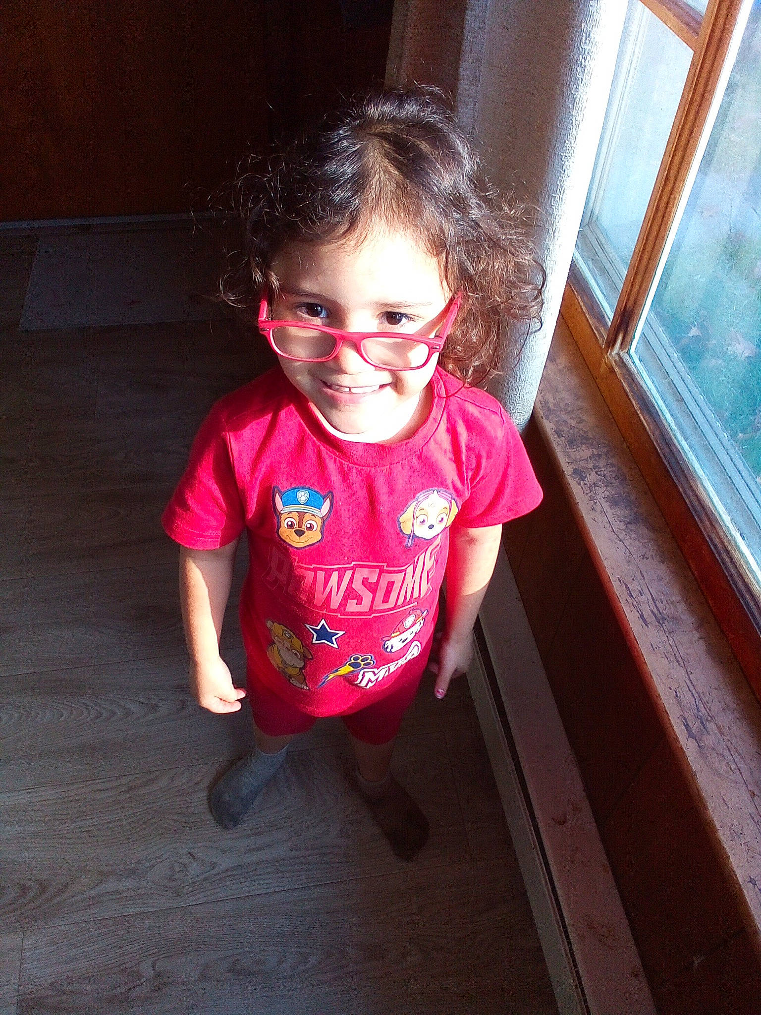 Makayla is registered to the contest to win money with this photo: baby_toddler_clothing, cheek, flash_photography, floor, flooring, fun, glasses, happy, iris, lip, magenta, person, pink, sleeve, smile, standing, sunglasses, tints_and_shades, toddler, window