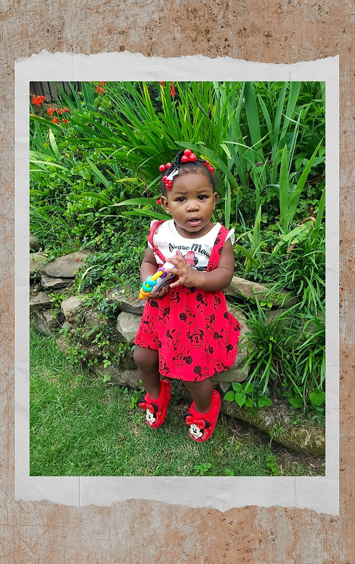 Brinleigh is registered to the contest to win money with this photo: adaptation, baby, baby_toddler_clothing, botany, child, garden, grass, grass_family, groundcover, happy, lawn, magenta, pattern, people_in_nature, person, picture_frame, plant, rectangle, sleeve, terrestrial_plant