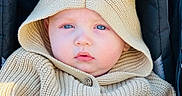 Makai joined the competition — help win amazing prizes! baby, child, blue_eyes, knitted_hoodie, beige_clothing, hood_with_ears, stroller, close_up, cute, portrait, infant, face, buttoned_sweater, warm_clothing, outdoor, soft_lighting, young_child, candid, expression, cozy