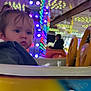 Solyanna a rejoint le concours — aidez-le/la à gagner de superbes lots ! amusement_ride, bright, child, colorful, curious, entertainment, expression, face, funfair, indoor, jacket, lights, person, pigtails, playful, portrait, reflection, seat, toddler, young