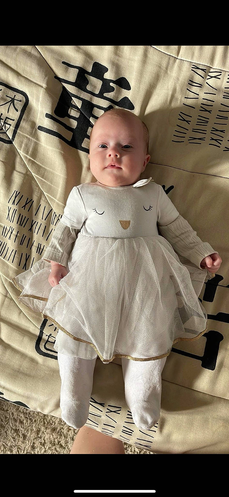 Illyana a rejoint le concours — aidez-le/la à gagner de superbes lots ! baby, baby_products, baby_toddler_clothing, child, fashion_design, happy, human_body, human_leg, knee, outerwear, pattern, person, sitting, skin, sleeve, standing, t_shirt, thigh, toddler, waist