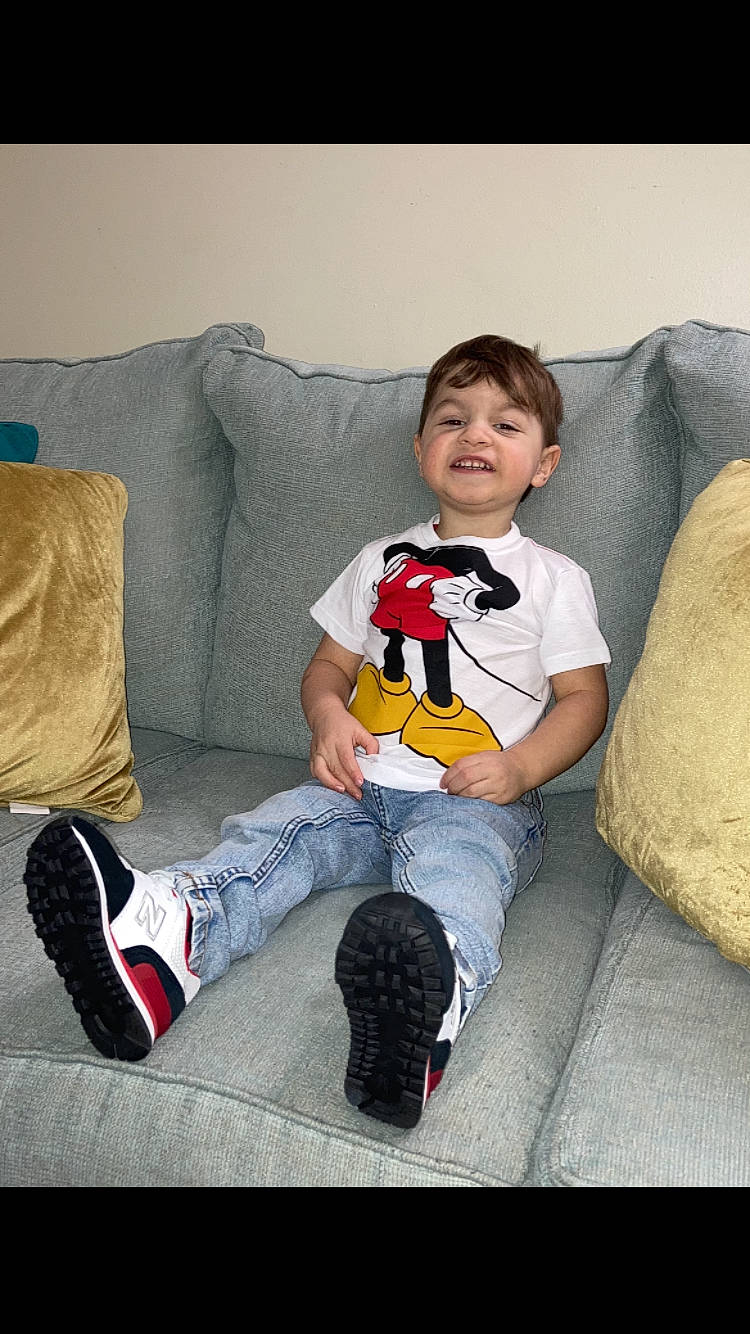 Aidryan joined the competition — help win amazing prizes! clothing, comfort, couch, flooring, fun, happy, head, human_leg, jeans, joy, knee, lap, leg, living_room, person, pillow, room, shoe, sitting, sneakers