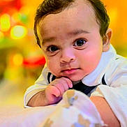 Kaiden is registered to the contest to win money with this photo: baby, infant, child, face, eyes, hand, clothing, white, teddy_bear, soft, lying_down, portrait, cute, indoors, colorful_background, closeup, skin, young, expression, focus