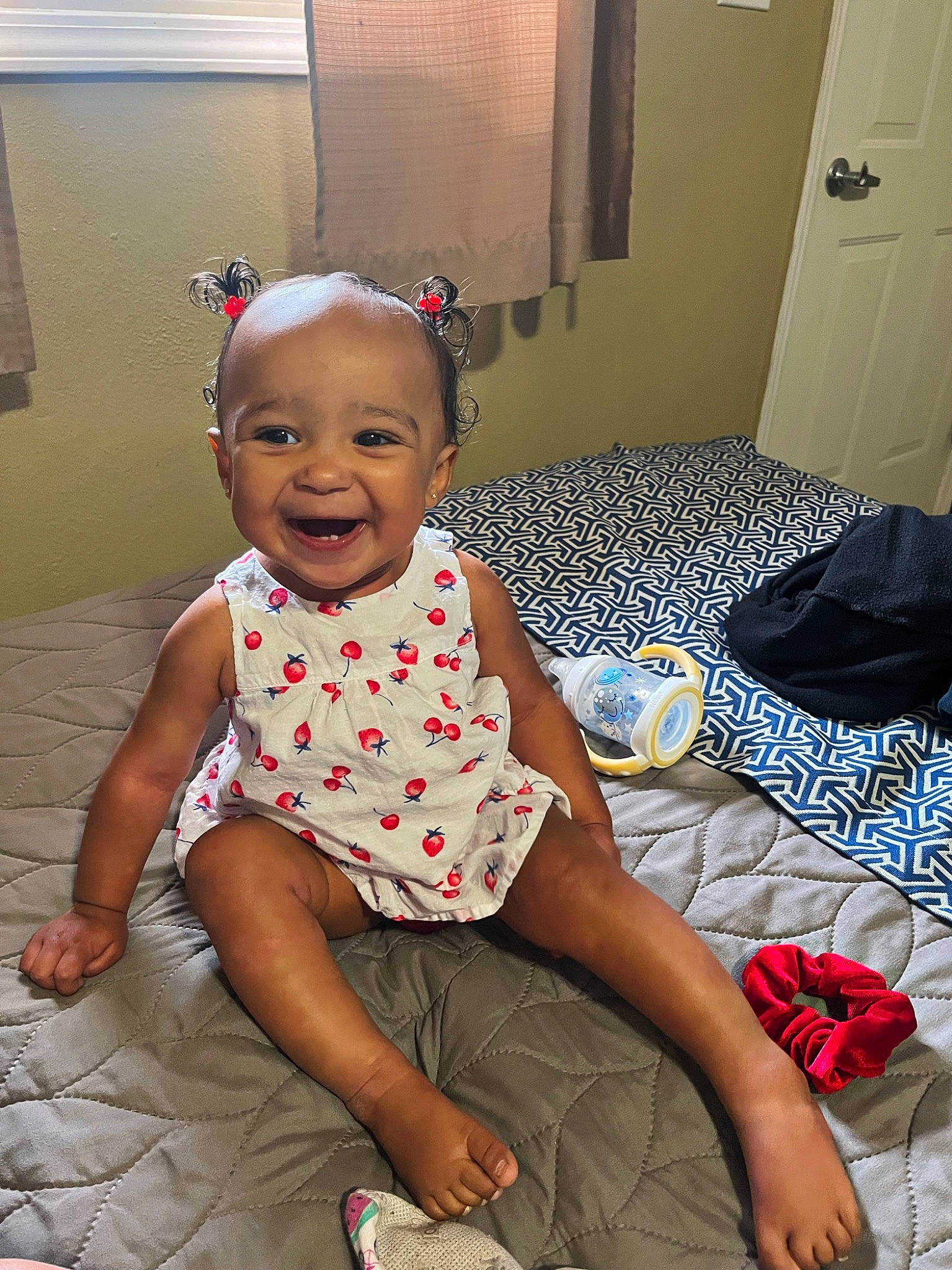 Tinsley is registered to the contest to win money with this photo: baby, baby_toddler_clothing, child, comfort, door, flooring, foot, fun, happy, human_leg, magenta, pattern, person, pink, sandal, sitting, sleeve, smile, textile, thigh