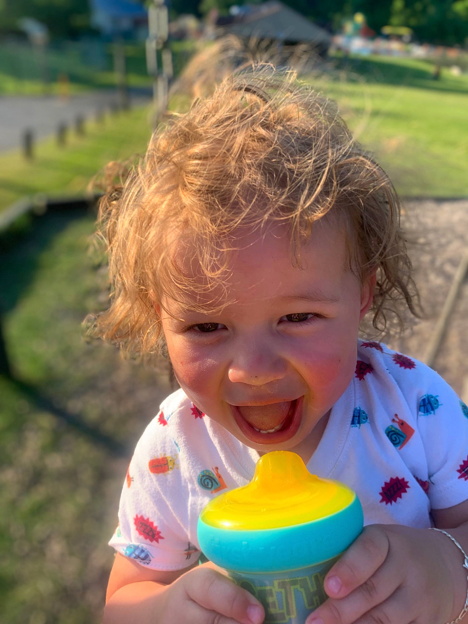 Khyree is registered to the contest to win money with this photo: baby_playing_with_toys, blue, cheek, child, fun, grass, green, happy, head, iris, joy, leisure, people_in_nature, person, play, recreation, sitting, skin, smile, summer