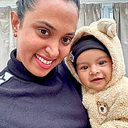 Diveinya joined the competition — help win amazing prizes! woman, baby, smiling, portrait, indoor, person, face, child, cute, happy, clothing, hoodie, teddy_bear, black_headwear, curtains, closeup, skin, eyes, hands, warm_clothing