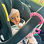Diveinya is registered to the contest to win money with this photo: baby, car_seat, infant, headband, pink_clothing, car_interior, toy, star_shaped_toy, window_shade, animal_print, child, safety_harness, seatbelt, cute, young_child, indoors, car_window, black_car_seat, pink_toy, child_seat