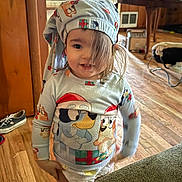 Gunner joined the competition — help win amazing prizes! child, toddler, pajamas, hat, face, hair, smile, diaper, wooden_floor, door, shoe, living_room, table, chair, toy, blanket, cozy, indoor, portrait, holiday