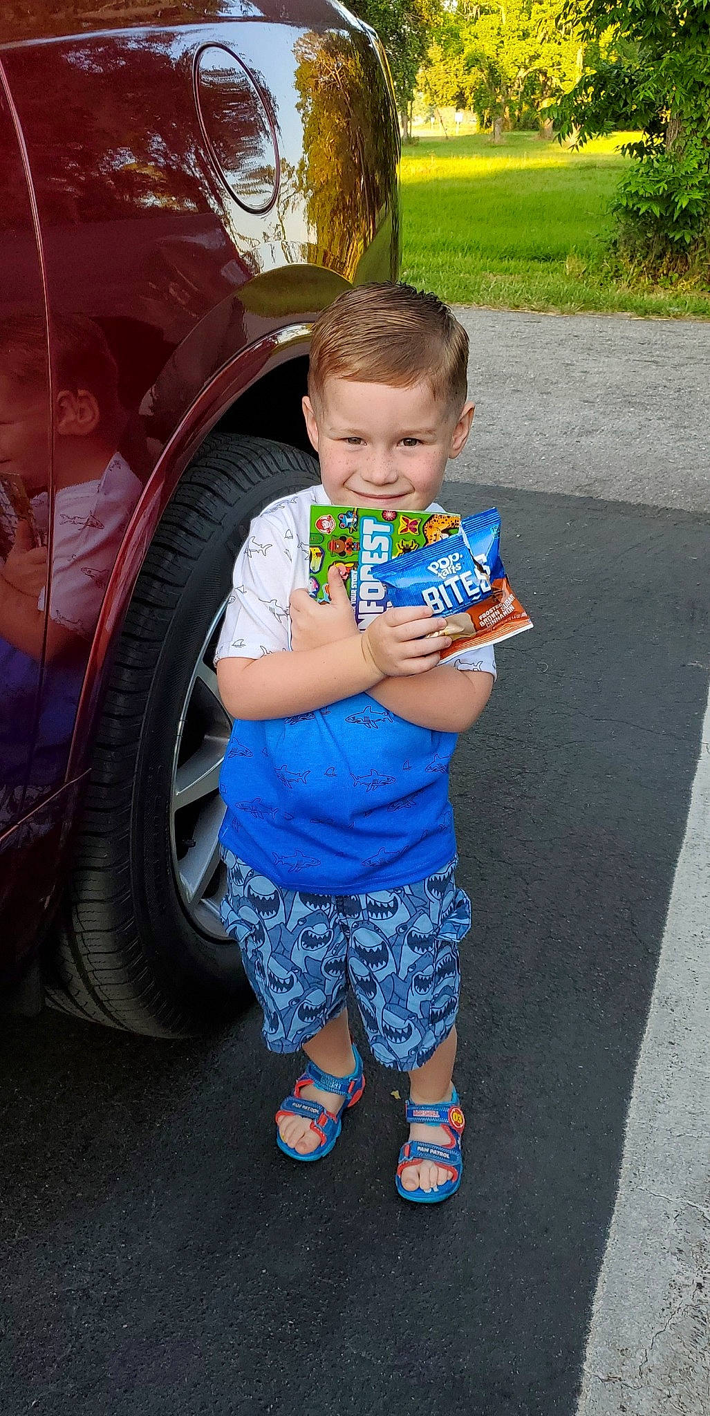 Lukas is registered to the contest to win money with this photo: automotive_design, automotive_exterior, automotive_lighting, automotive_tire, bumper, car, electric_blue, fender, fun, joy, leisure, motor_vehicle, person, plant, rim, shorts, summer, tire, toddler, tread