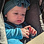 baby, child, car_seat, blue_headband, bow, blue_clothing, seatbelt, hands, curious, portrait, infant, cute, indoor, closeup, person, young_child, sitting, safety, face, expression