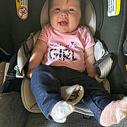 Elianna joined the competition — help win amazing prizes! baby, infant, car_seat, smiling, pink_shirt, mamas_girl, socks, blue_pants, happy, child, person, seat_belt, warning_label, indoor, cute, clothing, newborn, seat, straps, portrait