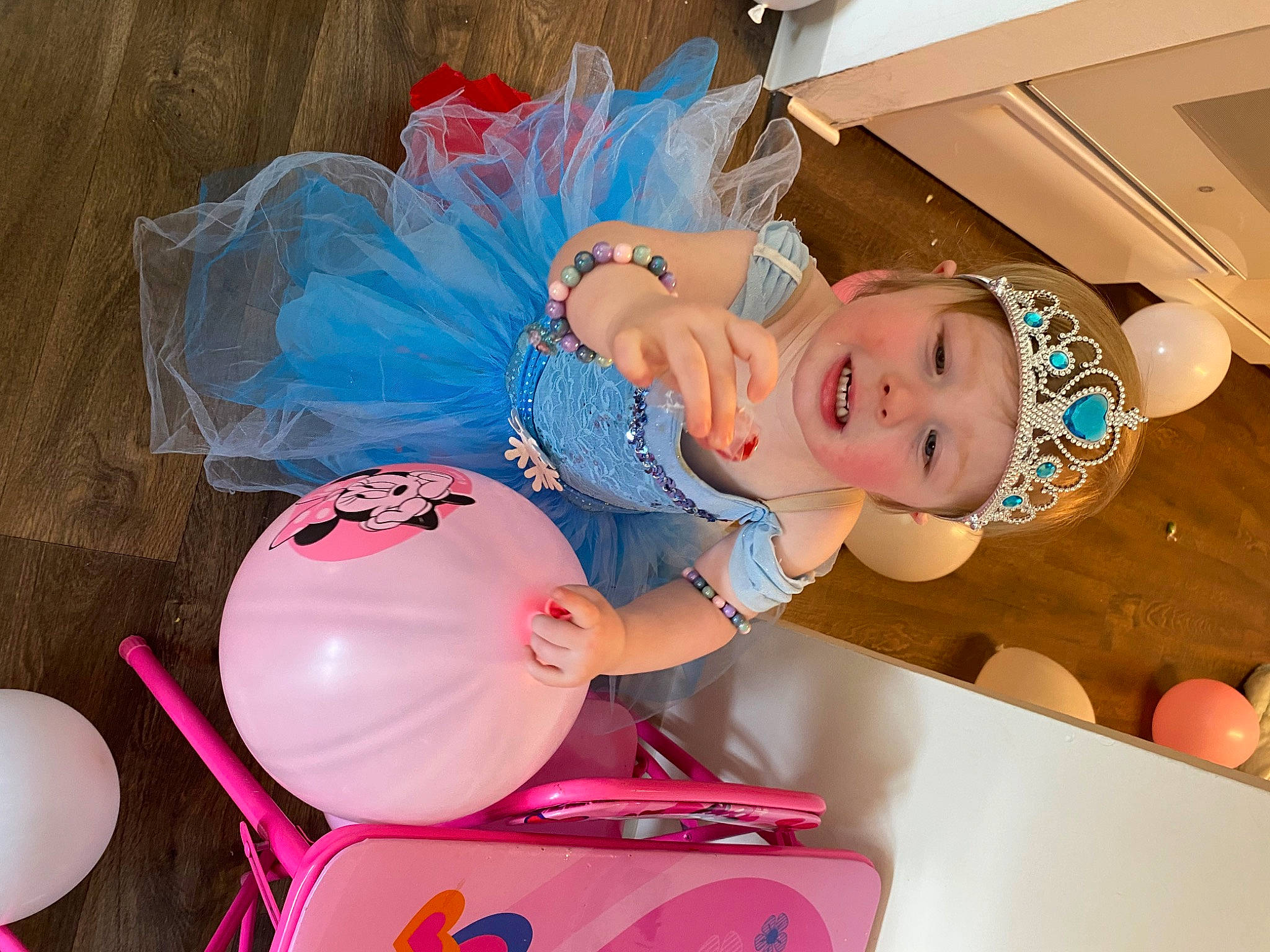 Tamra is registered to the contest to win money with this photo: baby, balloon, child, costume, event, fun, happy, hat, headgear, headwear, helmet, magenta, party, party_supply, person, personal_protective_equipment, pink, plastic, room, smile