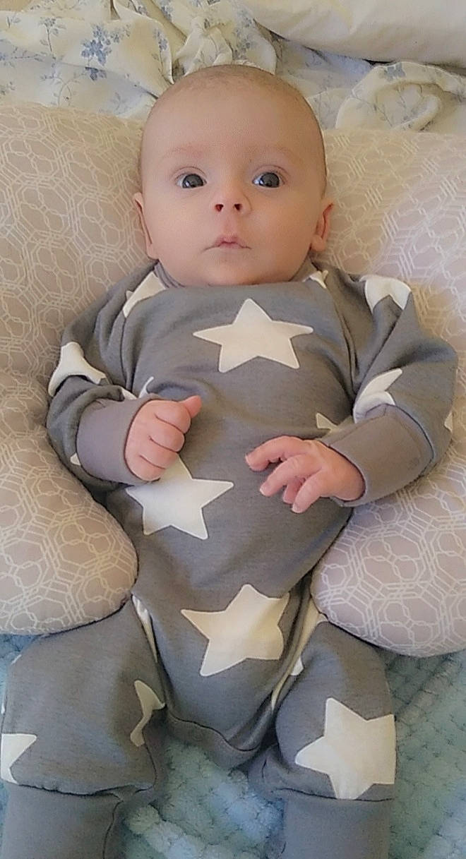 Aiden joined the competition — help win amazing prizes! arm, baby, baby_products, baby_toddler_clothing, cheek, chest, child, collar, comfort, face, gesture, head, human_body, lip, pattern, person, sitting, skin, sleeve, thumb