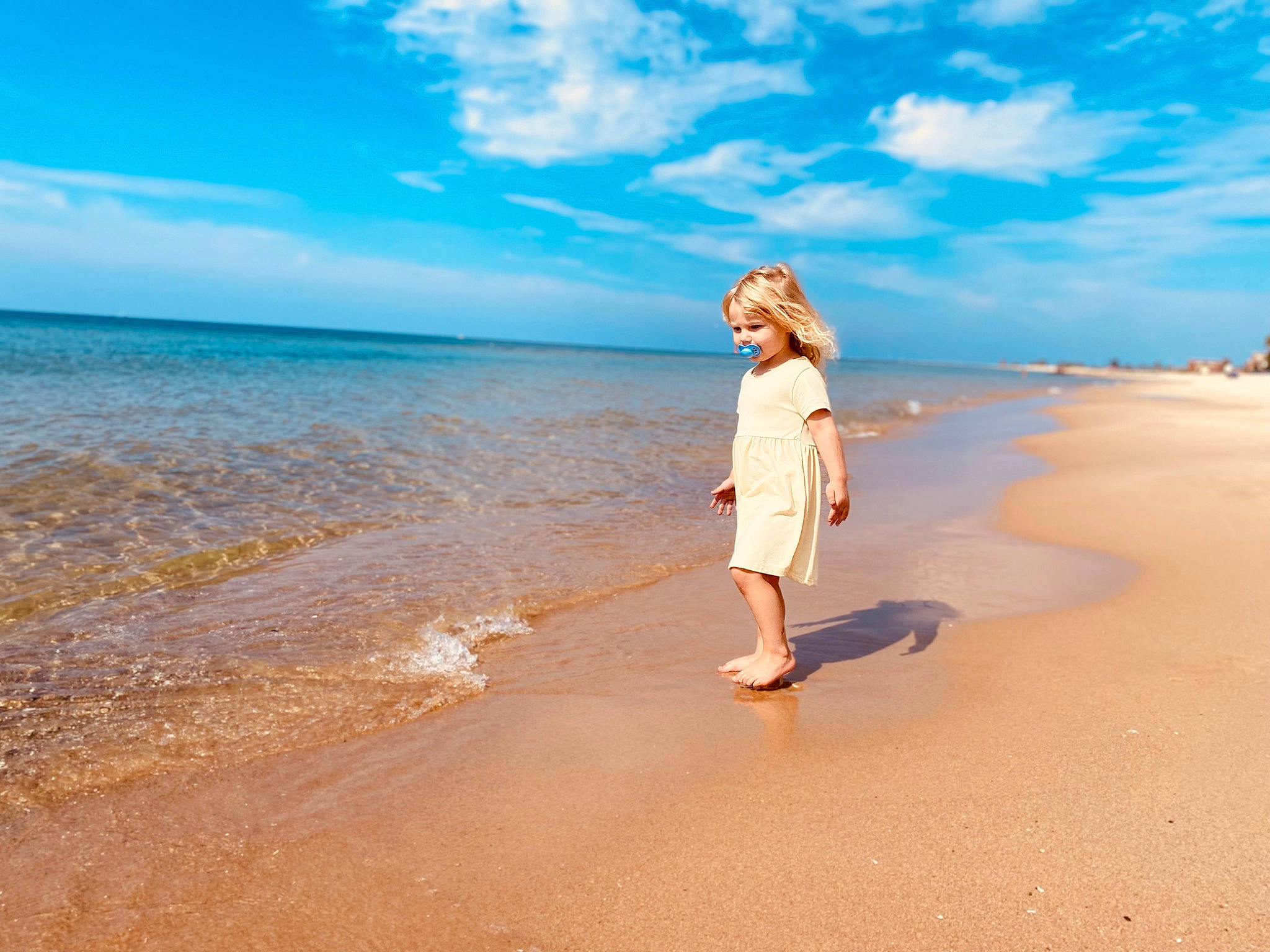 Harper is registered to the contest to win money with this photo: beach, blue, calm, cloud, coastal_and_oceanic_landforms, flash_photography, fun, happy, horizon, lake, landscape, leisure, people_in_nature, people_on_beach, person, sky, sunlight, travel, tree, water