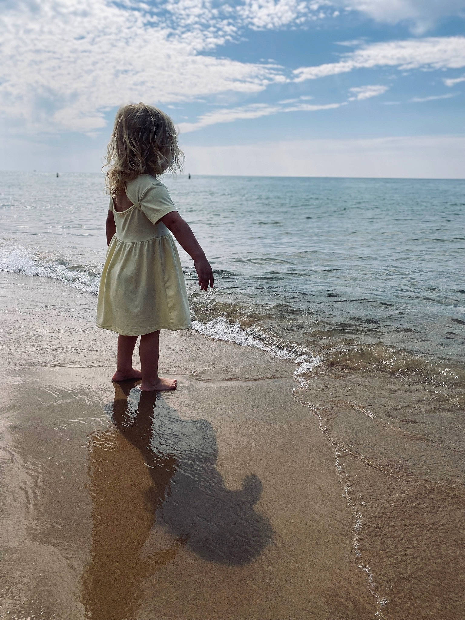 Harper is registered to the contest to win money with this photo: barefoot, beach, cloud, coast, coastal_and_oceanic_landforms, fun, happy, horizon, landscape, people_in_nature, people_on_beach, person, sand, shadow, sky, toddler, tropics, water, wave, wind
