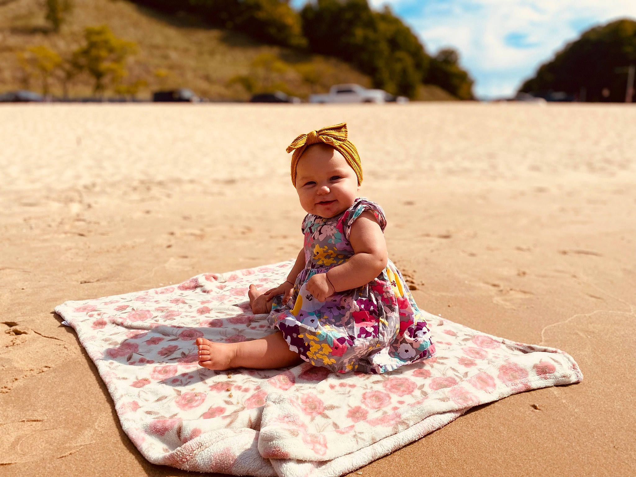 Haylin is registered to the contest to win money with this photo: baby_toddler_clothing, barefoot, beach, body_of_water, cloud, dress, fun, grass, happy, hat, joy, landscape, leisure, people_in_nature, people_on_beach, person, sand, sky, summer, toddler