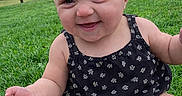 Bella is registered to the contest to win money with this photo: baby, bow, candid, child, chubby_legs, cute, face, grass, green_grass, hand, happy, headband, infant, onesie, outdoor, park, portrait, sitting, smile, trees