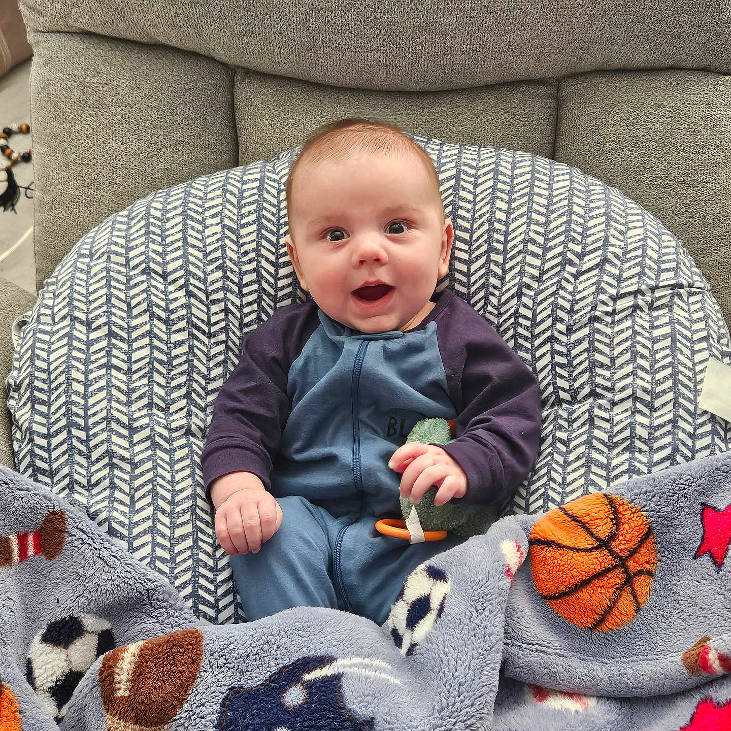 Wade is registered to the contest to win money with this photo: armchair, baby, blanket, chair, clothing, couch, crib, cushion, face, furniture, happy, head, homedecor, infantbed, pants, person, photography, portrait, quilt, sitting